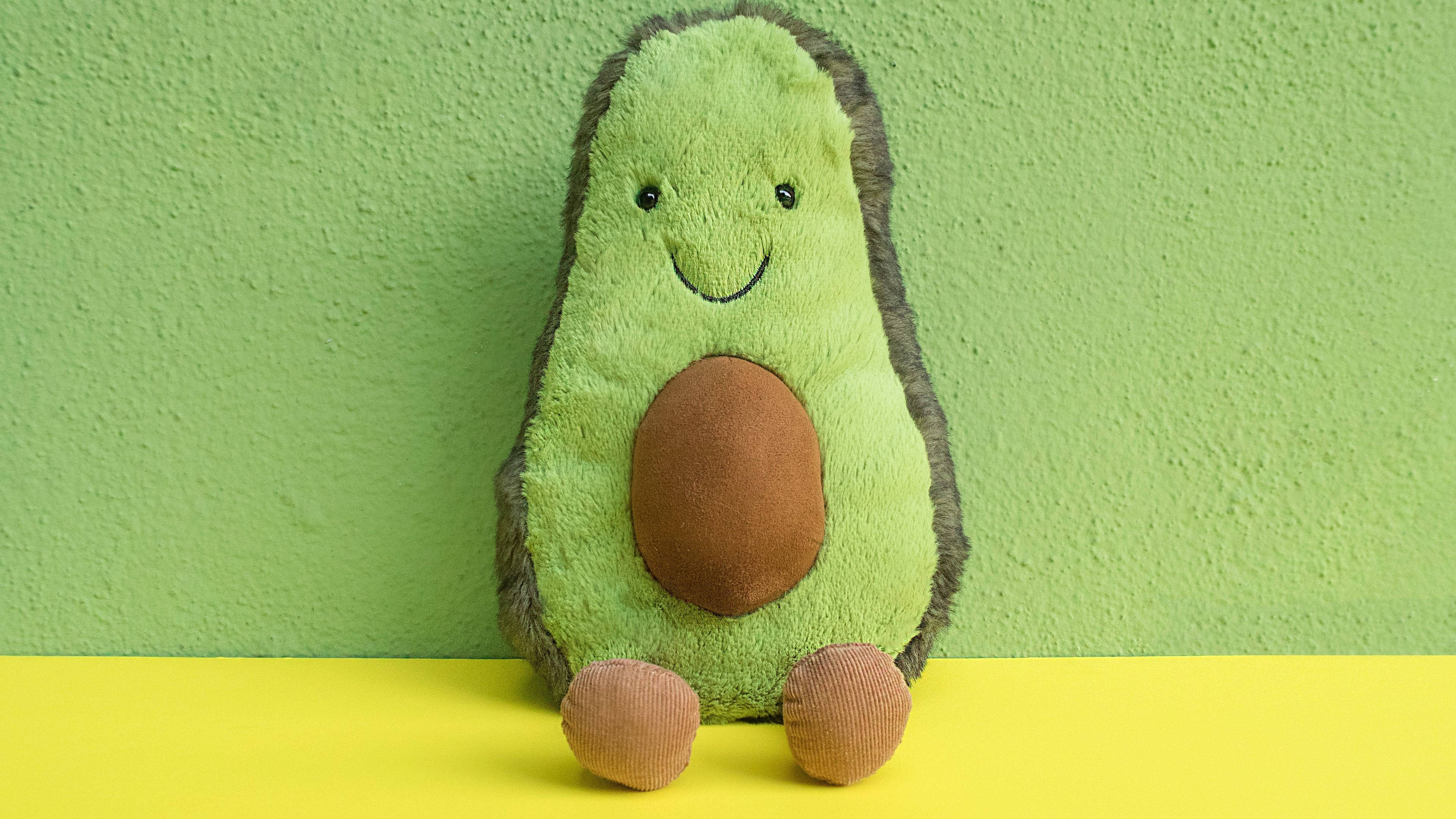 Avokado-lelun puolikas pastellinvihreällä taustalla Taustakuvat