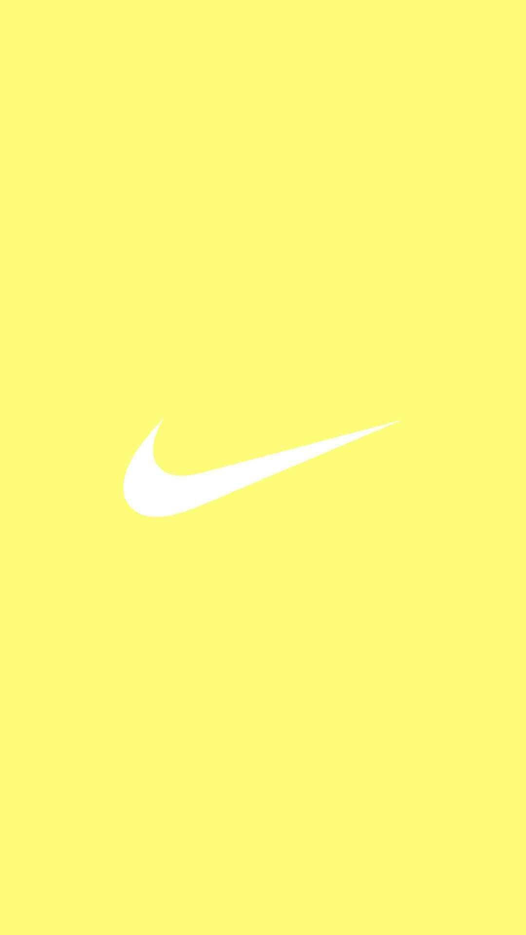 Hipnoottinen pastellikeltainen estetiikka ikonisella Nike-logolla Taustakuvat