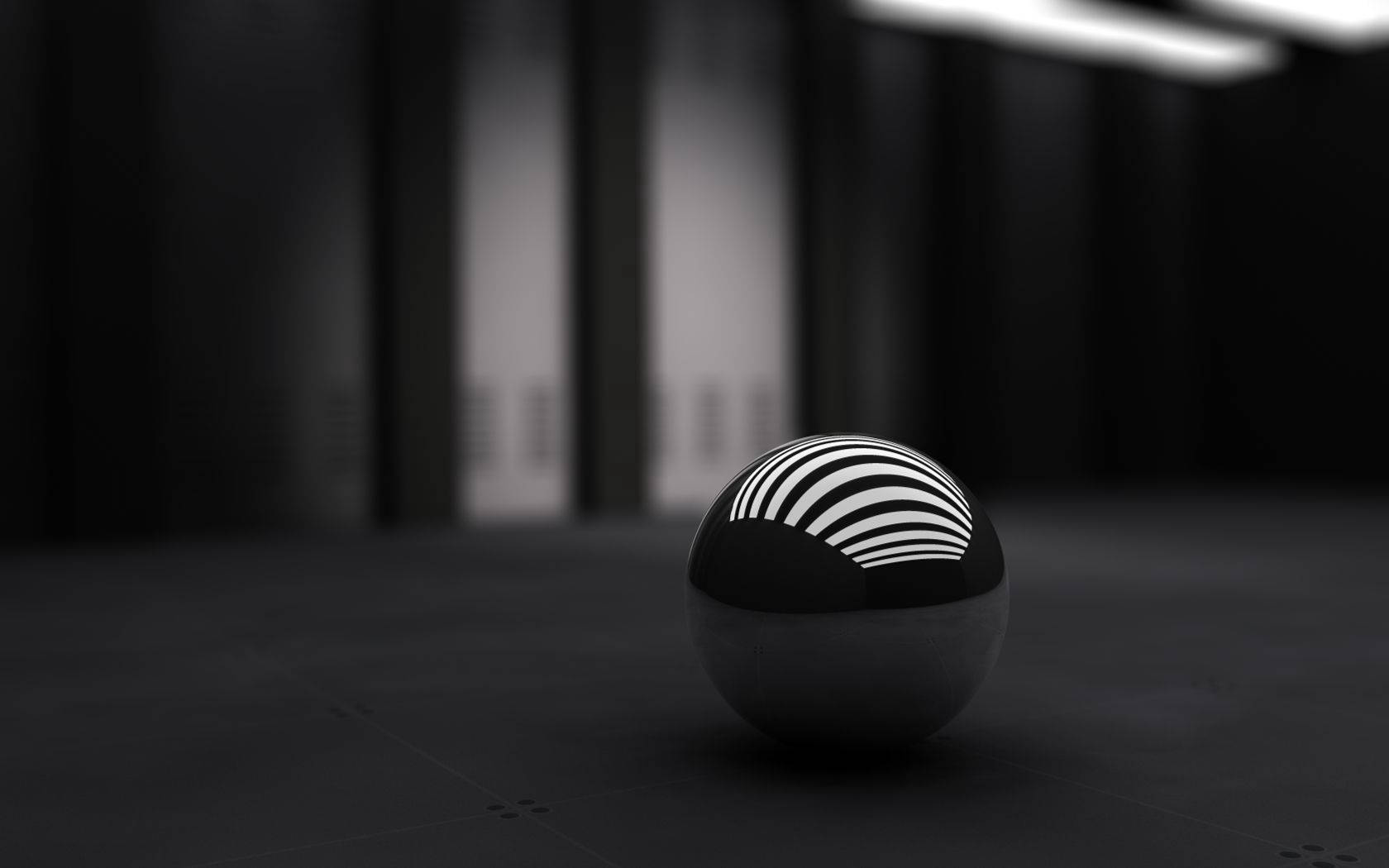 3D-työpöytätaustakuva pienestä mustasta pallosta.