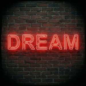 Inspiroiva neonpunainen DREAM-kyltti tiiliseinällä.