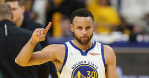 Steph Curry osoittaa oikealla kädellä ylös