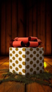Iso pilkullinen lahja punaisella rusetilla rustiikkisella lattialla takkatulen valossa. — Joululahjat Taustakuvat
