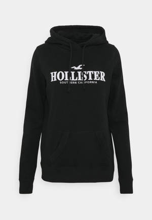 Hollisterin minimalistinen musta hupputakki -taustakuva — Siisti Taustakuvat